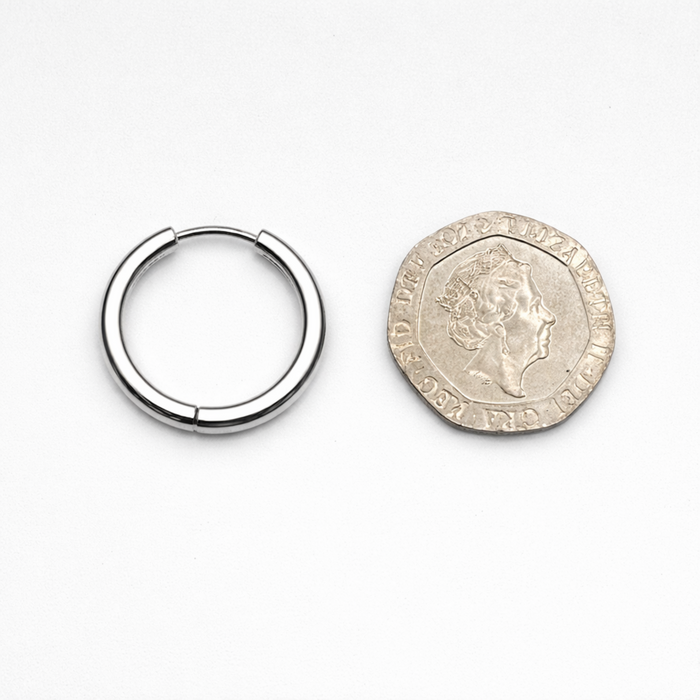 14mm stainless steel hoop earring next to a UK 20 pence coin for size comparison on white background