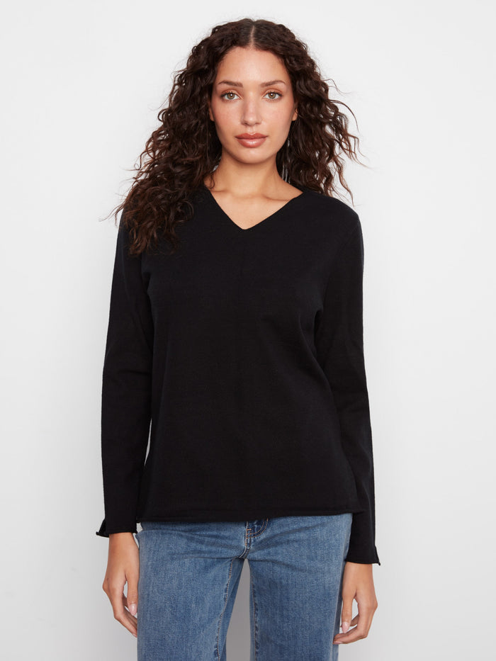 Black sweater with side slits for added style by Charlie B.