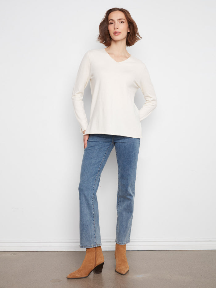 Relaxed fit sweater with long sleeves, ideal for layering in cooler weather. By Charlie B.