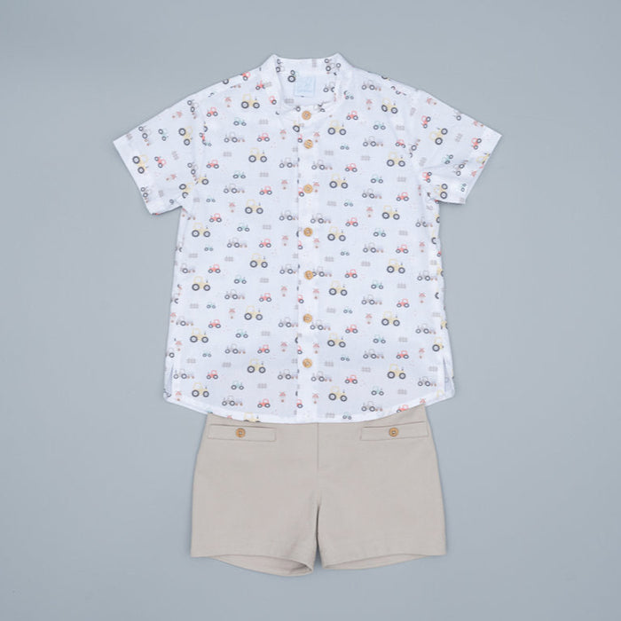 White shirt with colorful pattern and beige shorts on a white background