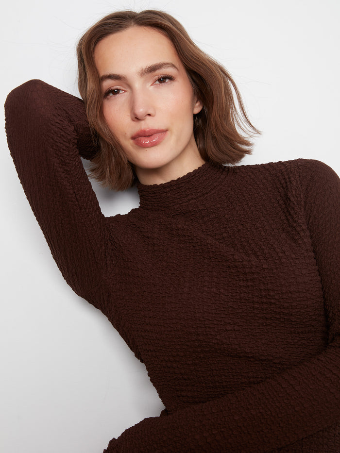 Adorned with delicate lettuce-edge trim, this top adds a touch of elegance to your wardrobe essentials by Charlie B.