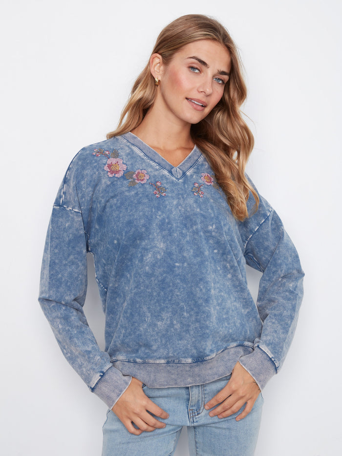 Denim blue terry top featuring a V-neck and intricate floral embroidery, crafted from stretch cotton by Charlie B.