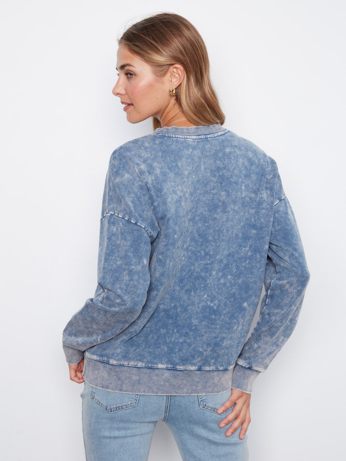 Embroidered floral design on denim blue terry top with drop shoulders, ensuring a relaxed fit by Charlie B.