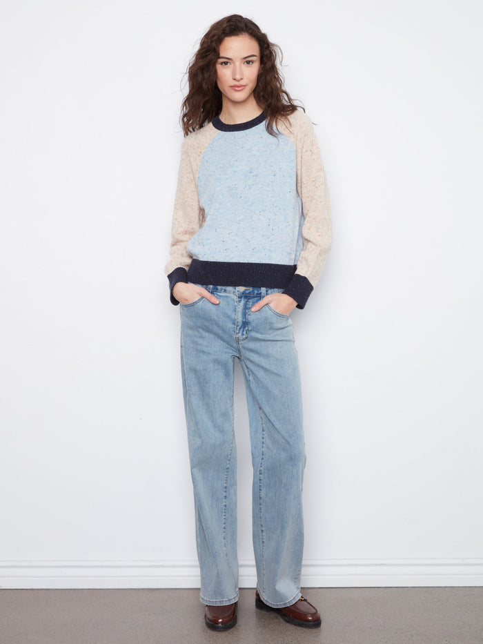 The speckled knit pattern adds a touch of texture and style to this versatile sweater, making it a wardrobe staple by Charlie B.