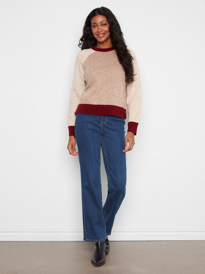 Earthy-toned sweater showcasing a speckled knit pattern, complete with contrast trim and crew neck by Charlie B.