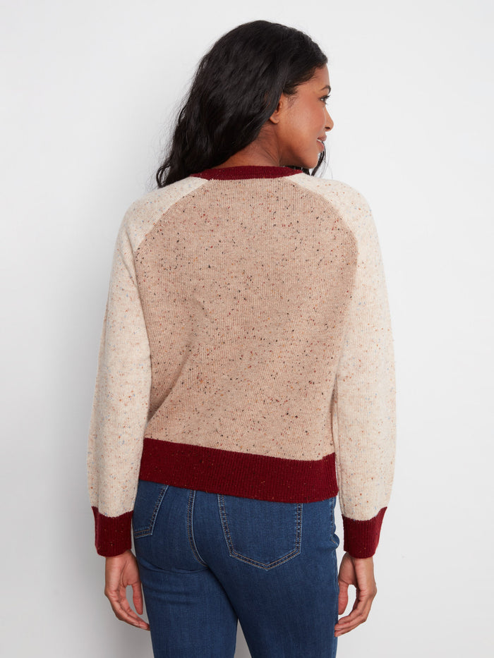 Speckled knit sweater in neutral tones, highlighted by its elegant contrast trim and long raglan sleeves by Charlie B.