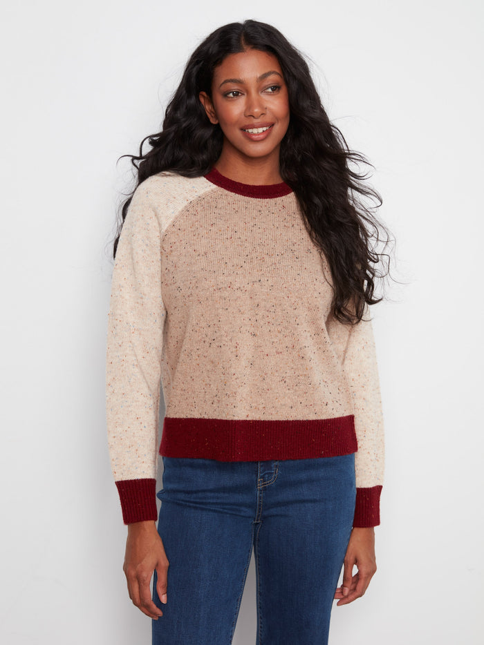 Stylish beige sweater featuring a charming speckled pattern, complemented by contrast trim and crew neck design by Charlie B.
