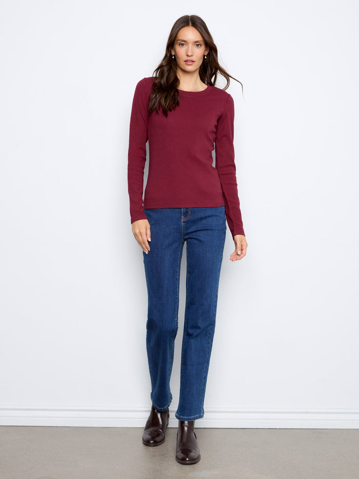 This slim fit top features long sleeves, perfect for layering or wearing alone during cooler days by Charlie B.