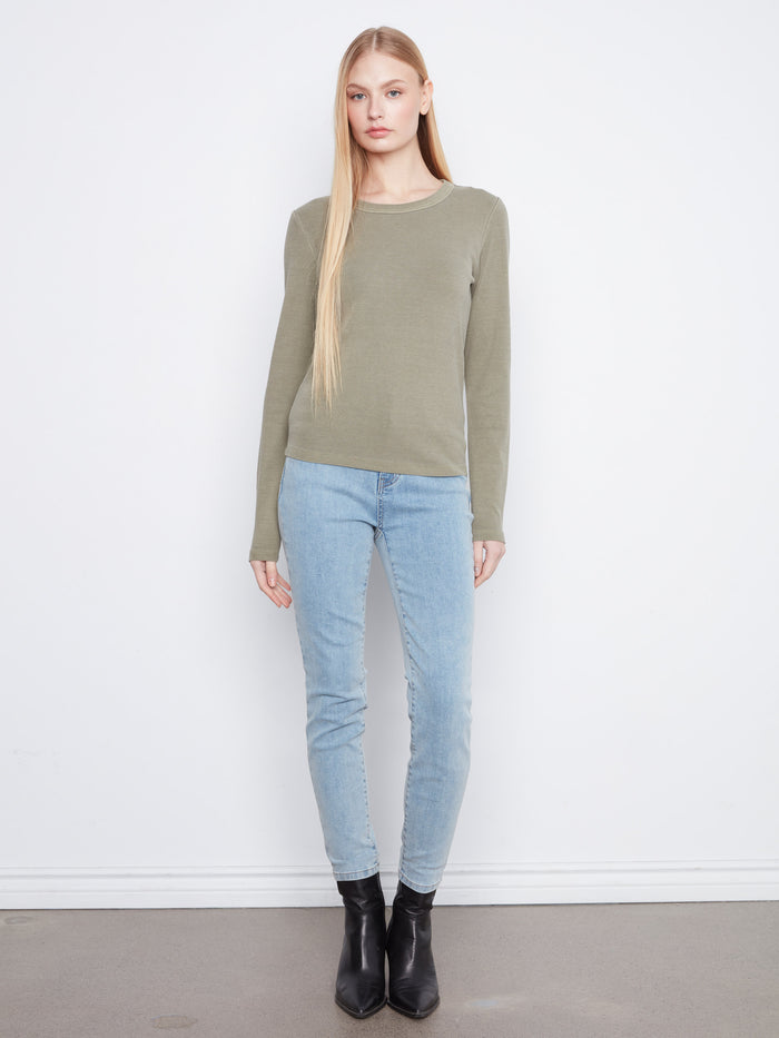 Elegant olive green garment showcasing its flattering slim fit design, ideal for layering or solo wear. By Charlie B.