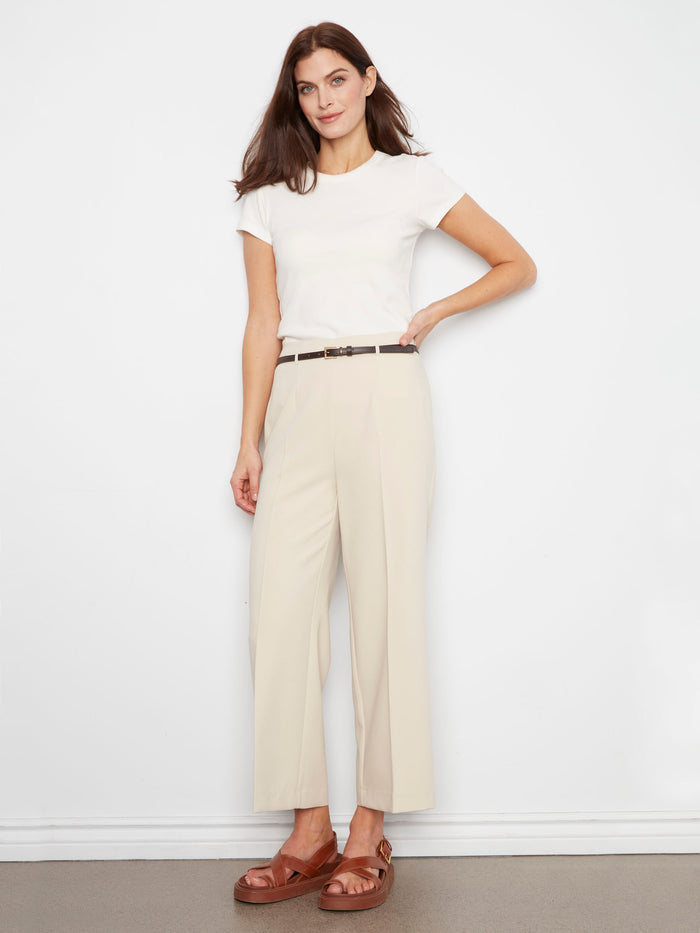 Featuring a belted waist, these beige pants offer both style and functionality for everyday wear. A versatile addition by Charlie B.