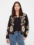 Embrace elegance with this collarless jacket, showcasing a stunning embroidered design. Perfect for any occasion. By Charlie B.