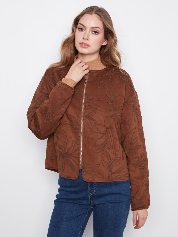 Faux suede bomber jacket in brown with intricate floral embroidery and convenient welt pockets by Charlie B.