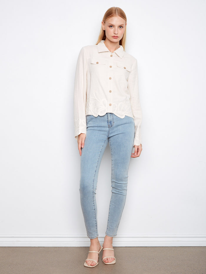 The front button closure of this jacket provides both functionality and style, making it a wardrobe essential by Charlie B.