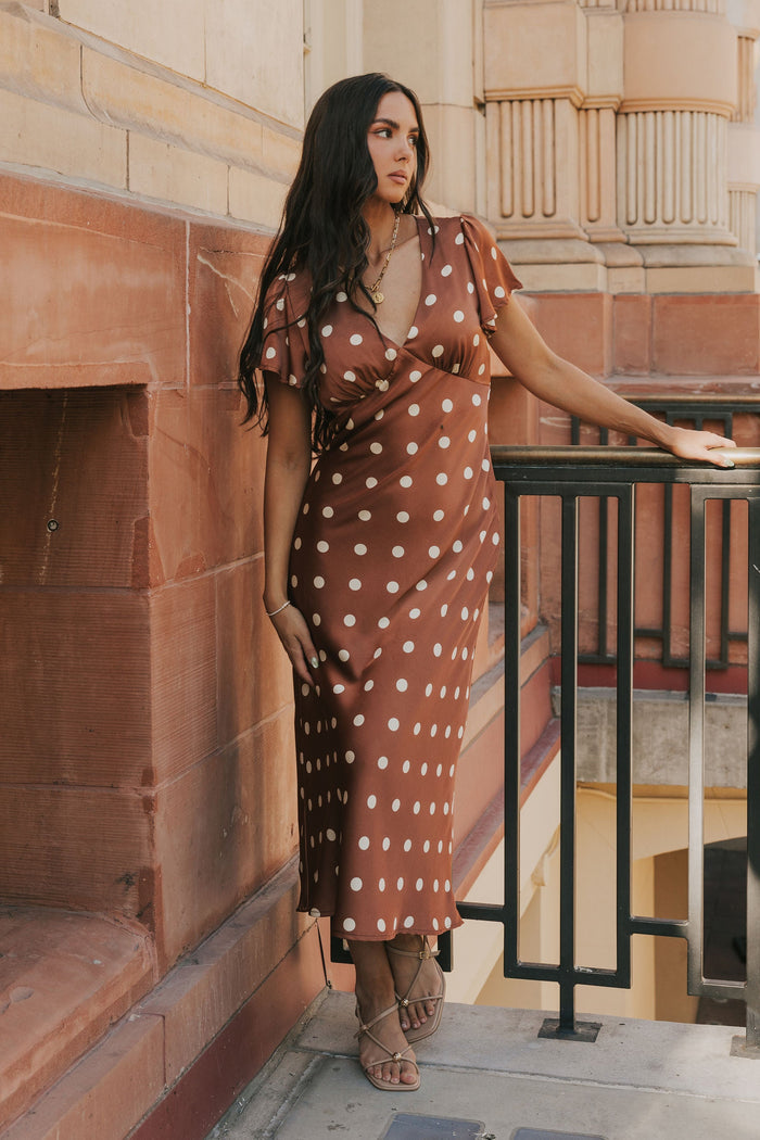 brown polka dot satin dress with flutter sleeves lifestyle