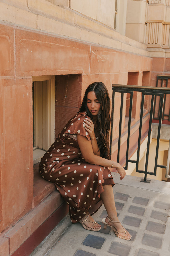 brown polka dot satin dress with flutter sleeves lifestyle