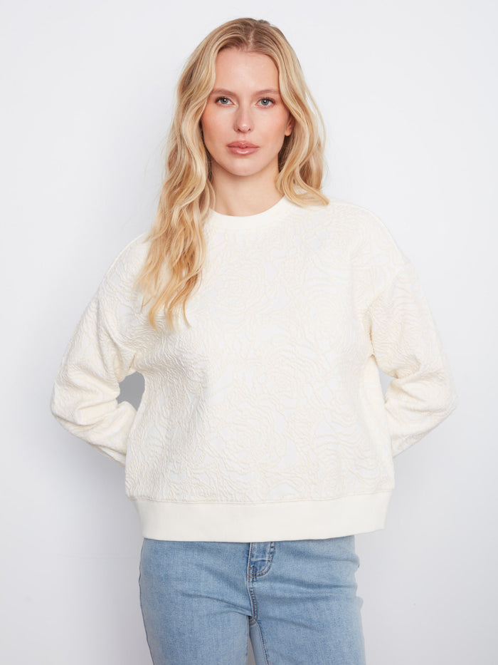 Buttercream sweatshirt featuring a relaxed fit and elegant floral soutache design, perfect for casual wear by Charlie B.