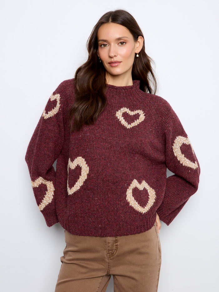 The cozy mock neck on this burgundy sweater is complemented by whimsical heart patterns, making it both stylish and warm by Charlie B.