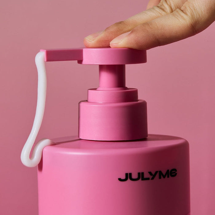 Close-up of JULYME Damage Care Perfume Hair Treatment 500ml pump dispenser being pressed, showcasing the product's design and texture.