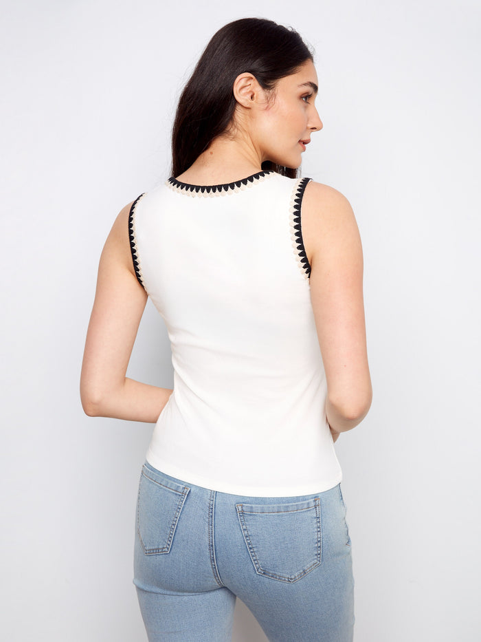 Stylish white tank featuring detailed crochet along the edges, complemented by a classic scoop neck design by Charlie B.