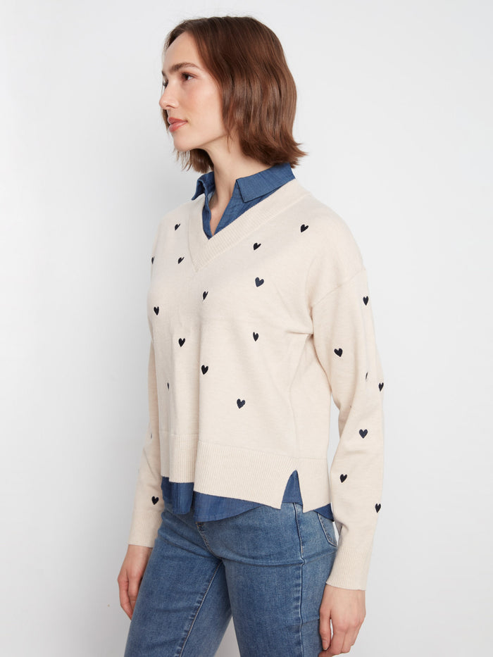 This charming sweater showcases drop shoulders and an array of embroidered hearts for a playful touch by Charlie B.