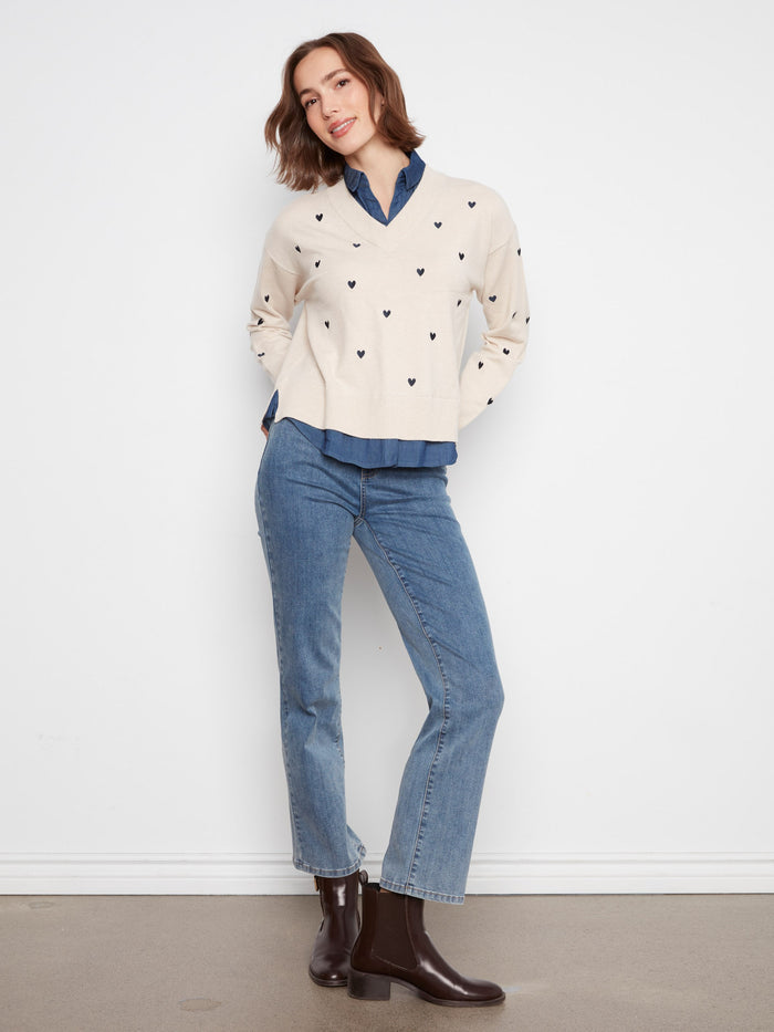 The V-neckline adds sophistication to this heart-embroidered sweater, complemented by its layered design by Charlie B.