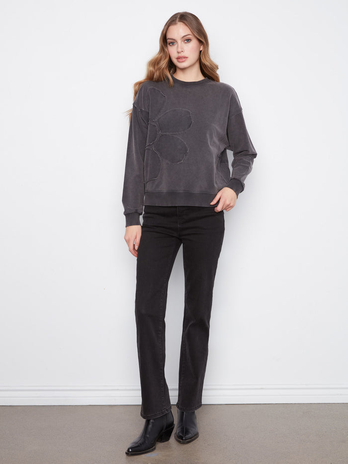 Charcoal top with ribbed neck, hem, and cuffs paired with floral applique by Charlie B.