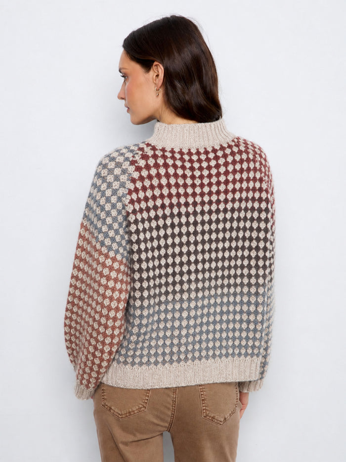 Elegant knit pattern on this cozy top enhances its unique charm and aesthetic appeal, suitable for any occasion. By Charlie B.