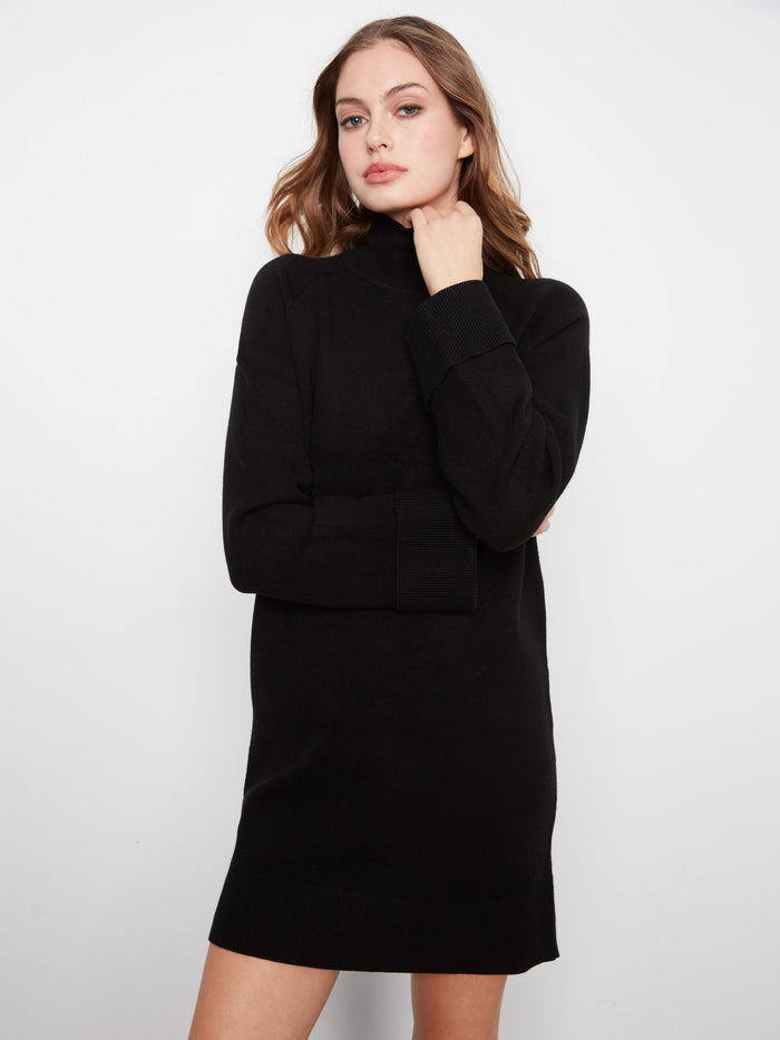 Chic black mini dress featuring a mock neck and stylish long raglan sleeves. A versatile piece for any wardrobe by Charlie B.