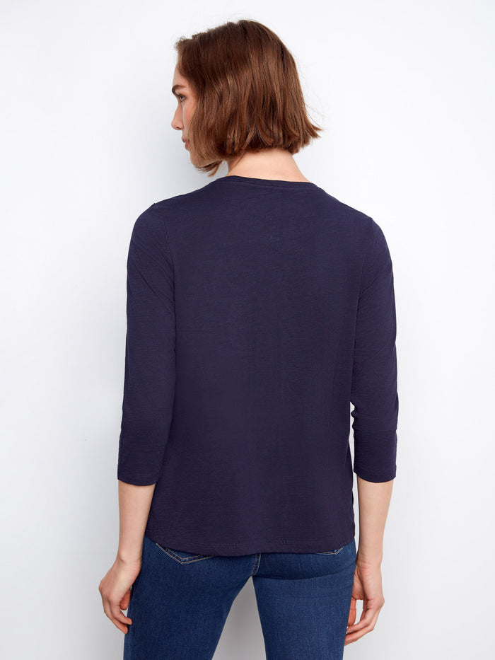 Stylish top with a slit hem design, offering ease of movement and modern flair. Fashionably created by Charlie B.