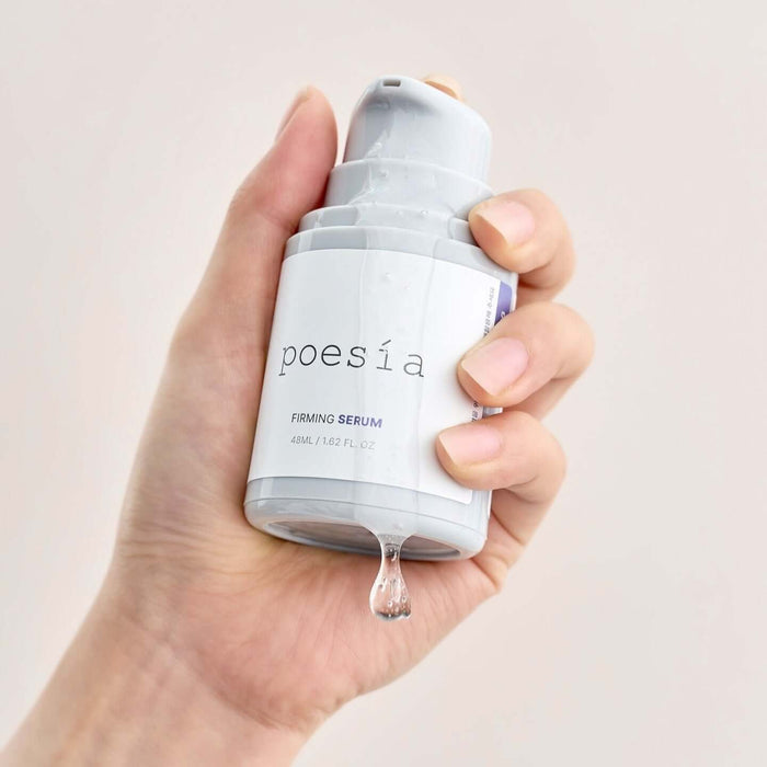 Hand holding POESÃA Hydro Phyto Collagen Deep Farming Ampoule Serum 48ml bottle with drop of serum.