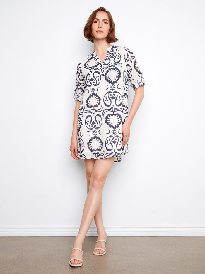 The dress features a chic chest pocket, adding both style and functionality to the overall design by Charlie B.