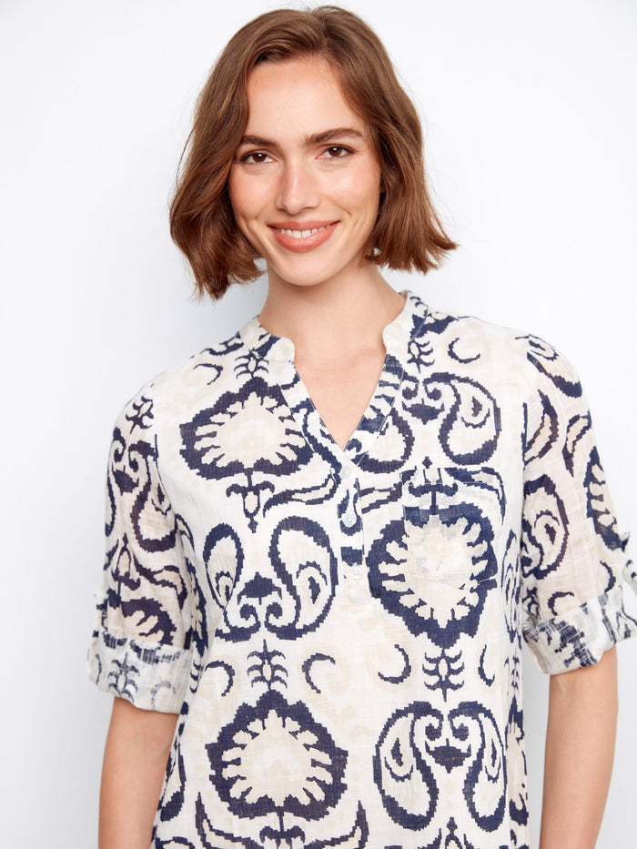 This piece highlights a half-button design, offering versatility and easy wearability by Charlie B.