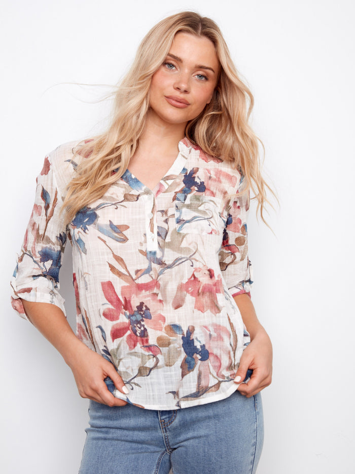 This floral blouse features a convenient chest pocket, blending style and functionality seamlessly. Ideal for everyday wear by Charlie B.