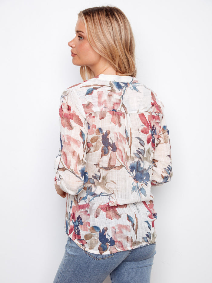 Enjoy the adjustable roll-up sleeves on this beautiful floral blouse, providing comfort and adaptability throughout the day by Charlie B.
