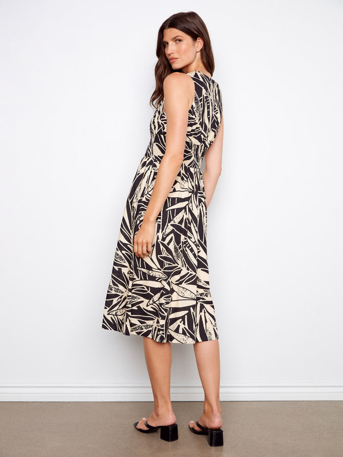 Elegant sleeveless dress in retro floral print with hidden pockets for convenience by Charlie B.