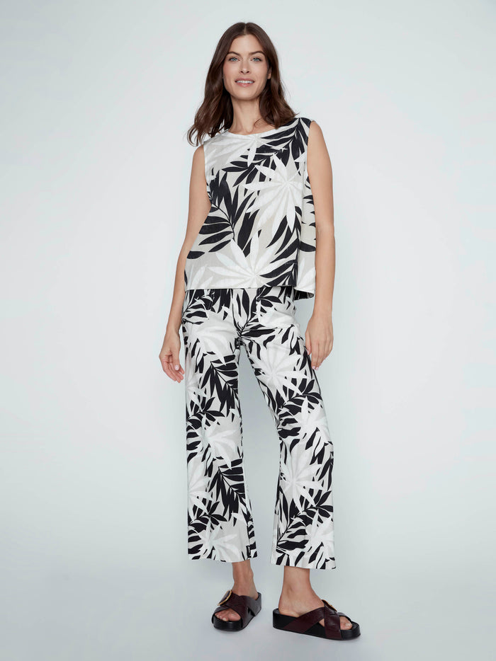 Step into style with this relaxed fit top featuring intricate back button details that add elegance to your outfit by Charlie B.
