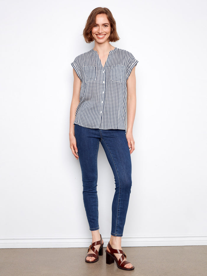 Chic navy gingham blouse with cap sleeves and elegant chest pockets, perfect for casual wear by Charlie B.