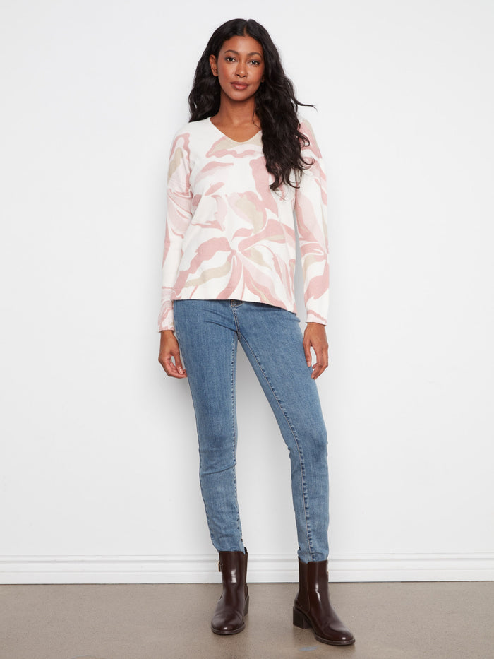 This sweater features long sleeves, offering warmth and elegance for cooler days. A stylish addition to your wardrobe by Charlie B.