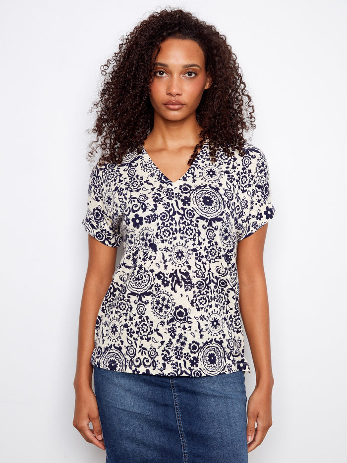 Patterned blouse featuring a V neckline, crafted from a soft linen blend for comfort and style. By Charlie B.