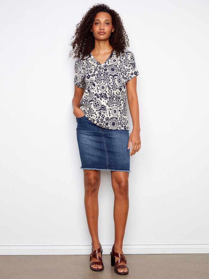 Stylish top showcasing folded cuffs that add an elegant touch to the design. Made from quality fabric. By Charlie B.