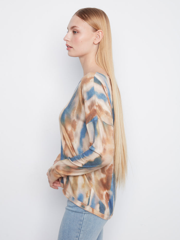 Knit top with long sleeves and a unique abstract pattern in earthy colors, adding flair to any outfit by Charlie B.