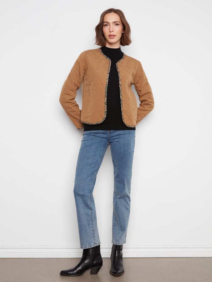 Elegant quilted jacket showcasing patch pockets for practicality and style in one piece. By Charlie B.