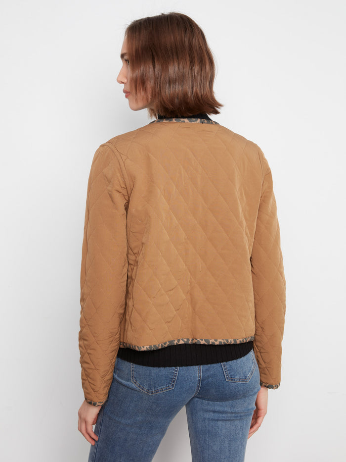 Trendy leopard print outerwear boasting convenient patch pockets, blending fashion and utility seamlessly. By Charlie B.