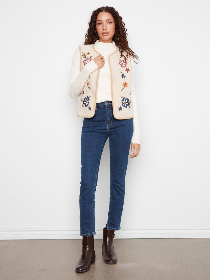 Reversible sleeveless vest with elegant floral embroidery on the sherpa side for added style by Charlie B.