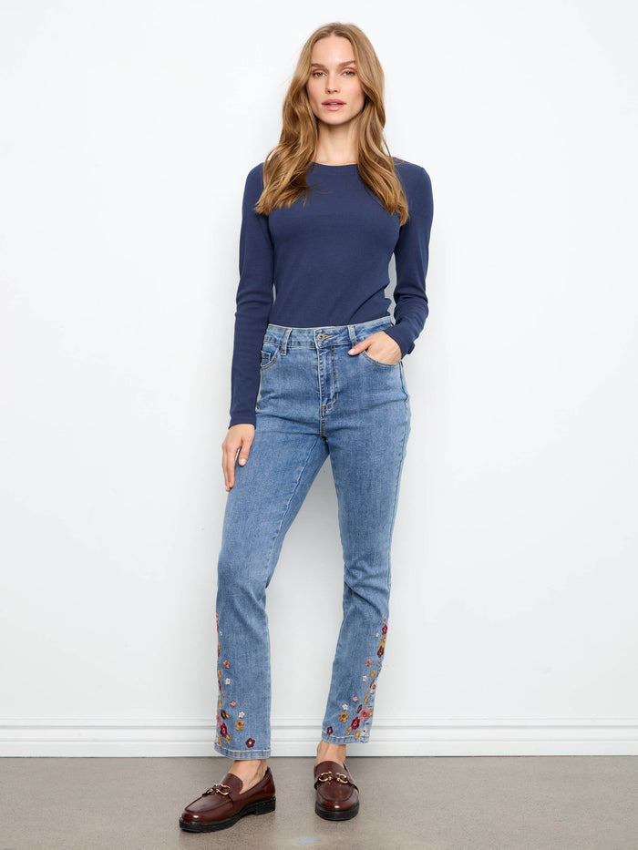 Medium blue jeans with a slim leg and vibrant floral embroidery at the hem, crafted in stretch denim by Charlie B.