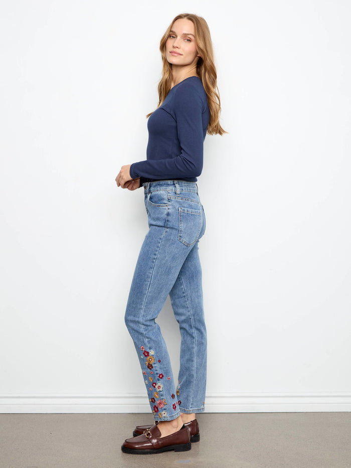 These jeans feature an ankle length design with intricate floral embroidery, perfect for a stylish look by Charlie B.