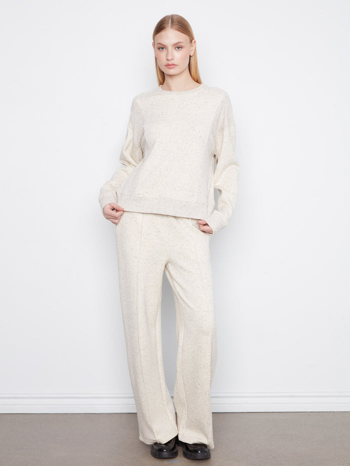 The relaxed fit makes it ideal for layering over other outfits effortlessly. By Charlie B.