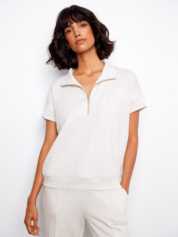 Light grey top with a stylish half-zip feature, perfect for casual outings. The short sleeves add comfort and ease by Charlie B.