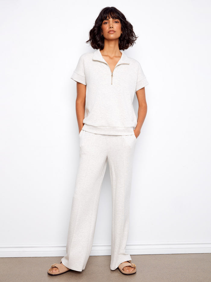 This elegant top features a mock neckline, enhancing its sophisticated look. The heather light grey color is versatile by Charlie B.