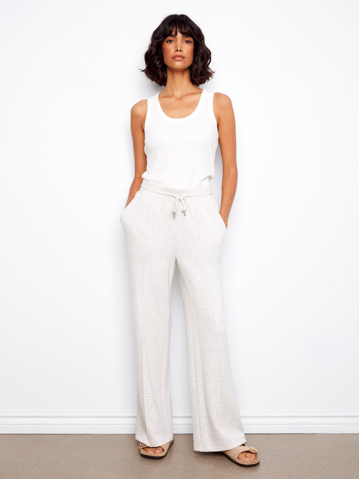 An elastic waistband with drawstrings ensures a perfect fit while maintaining comfort throughout the day. By Charlie B.